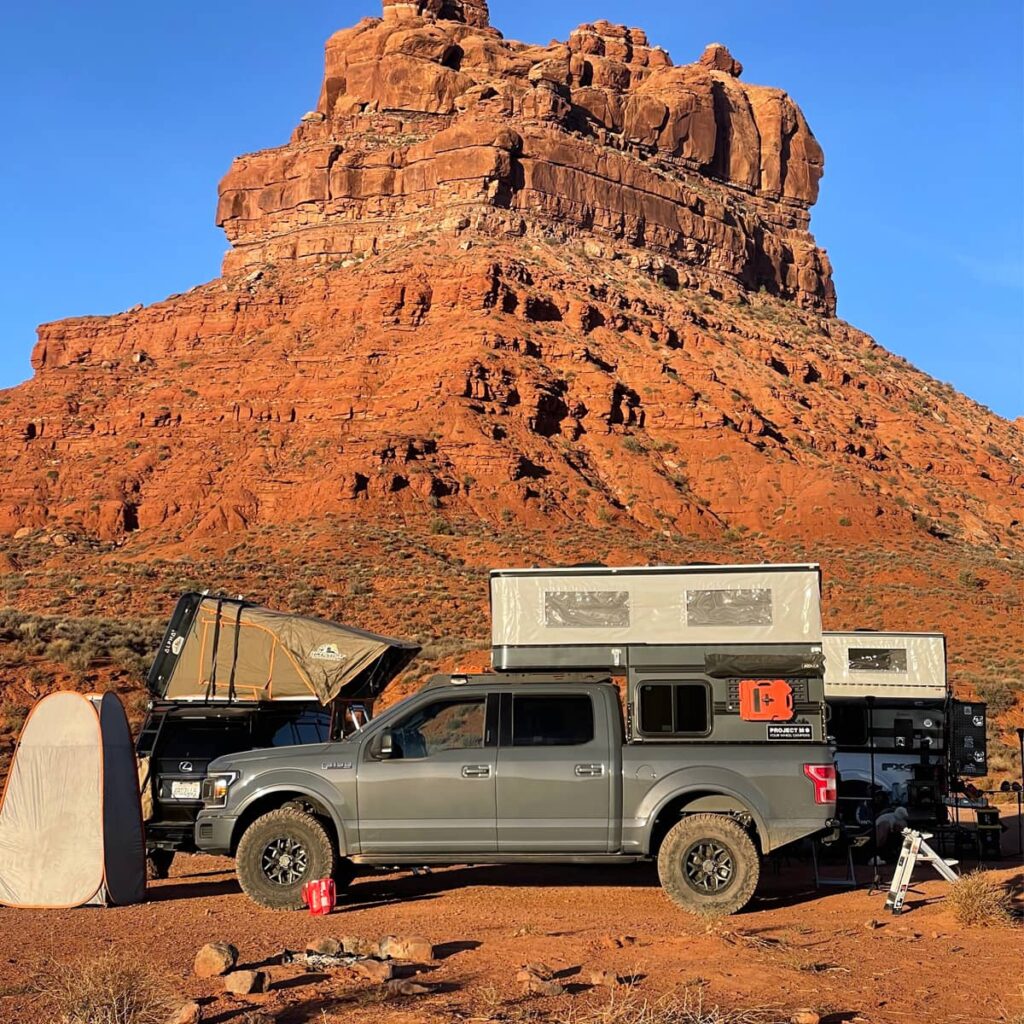 Ford f150 with a pop-up truck topper by Four Wheel Campers