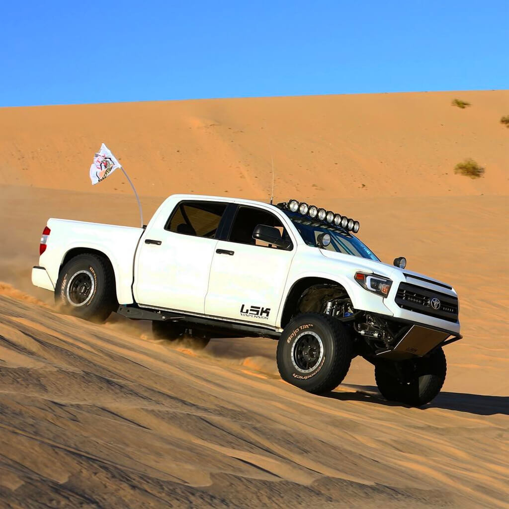Badass Toyota Tundra prerunner jumping in the dunes