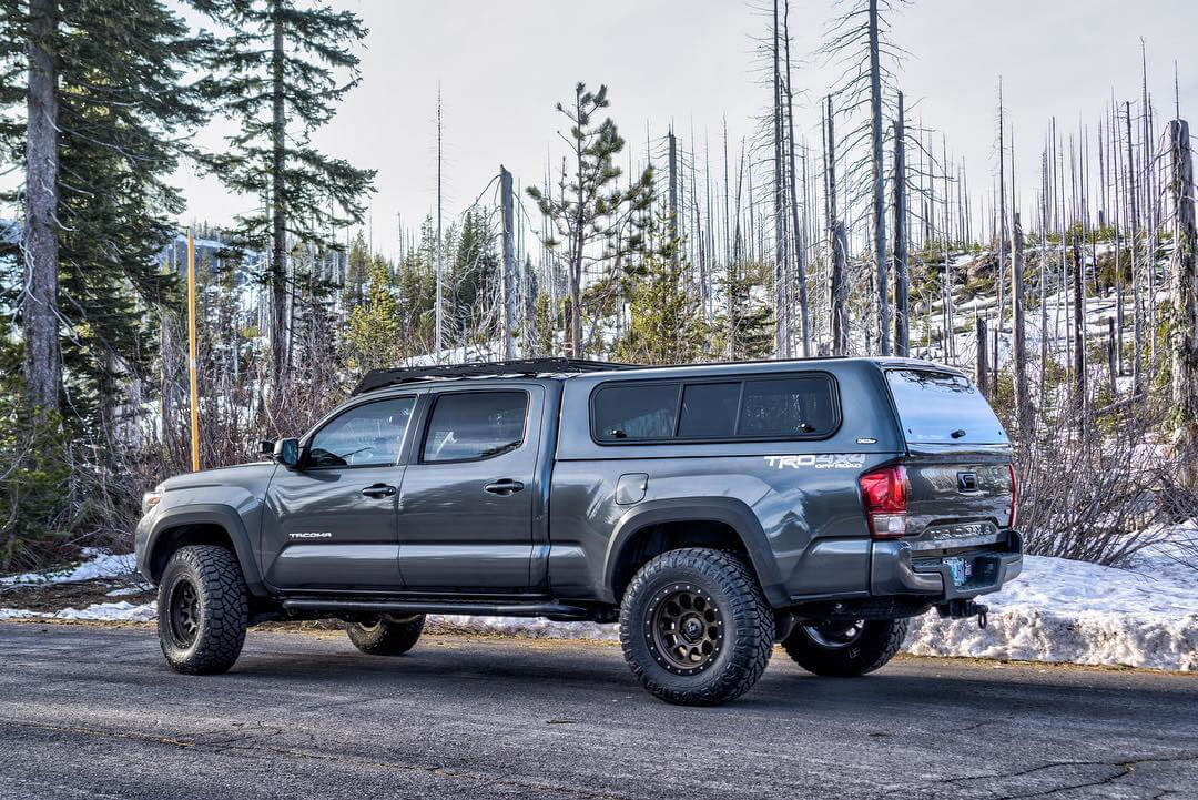 Lifted Toyota Tacoma with overland gear and Camper Shell