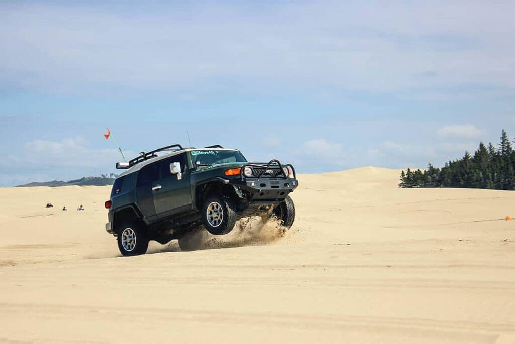 Lifted Toyota fj cruiser jumping dunes