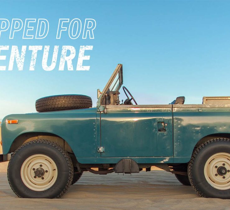 Land rover series III with a tire on the hood