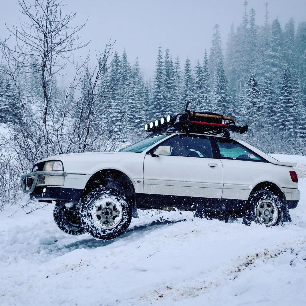Off-road spec Audi 90 Coupe with lifted suspension, oversized wheels and a roof rack