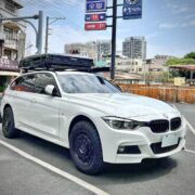 Timebox rooftop box in closed position on a white BMW F31 M Sport Touring on city street