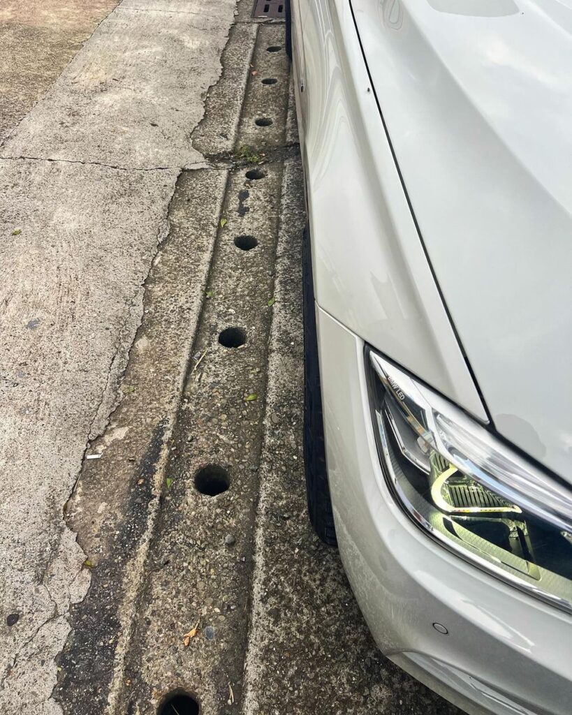 2015 BMW 320i F31 Touring in white parked flush against a curb showing ride height