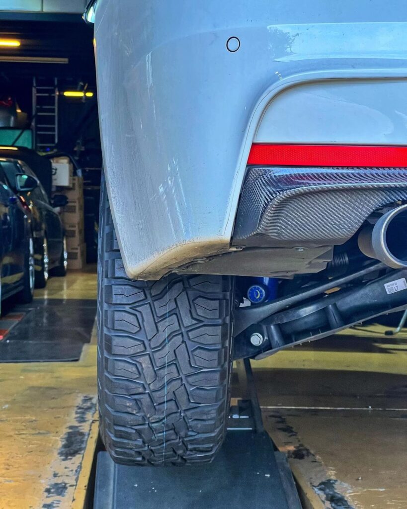 Toyo Open Country R/T tire fitted under the rear bumper of a lifted BMW F31