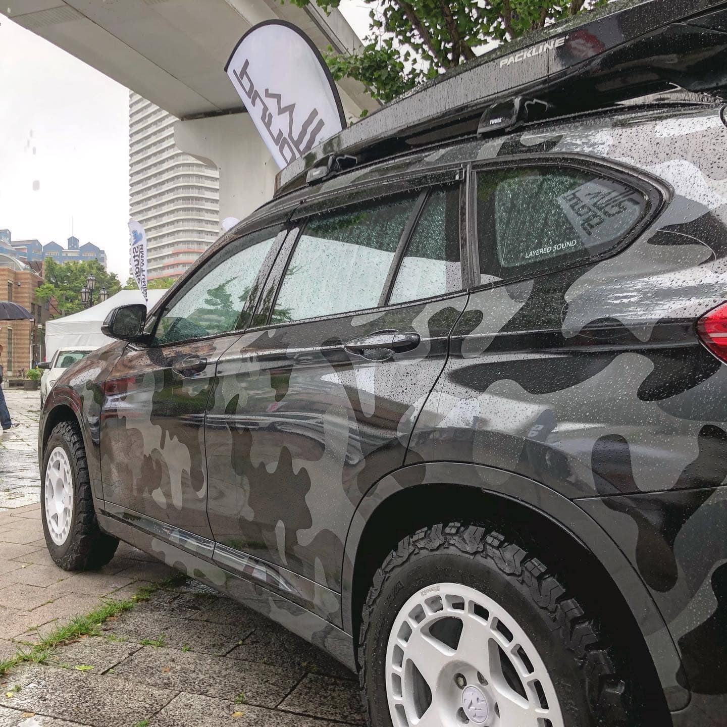BMW X1 Wrapped in black grey military camo with a roof rack