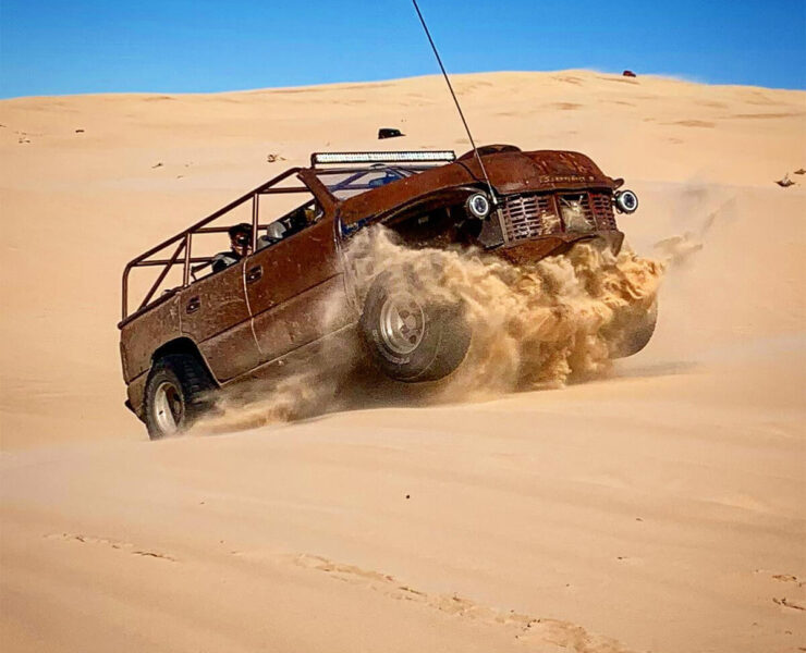 Jumbing dunes in a rat rod buggy