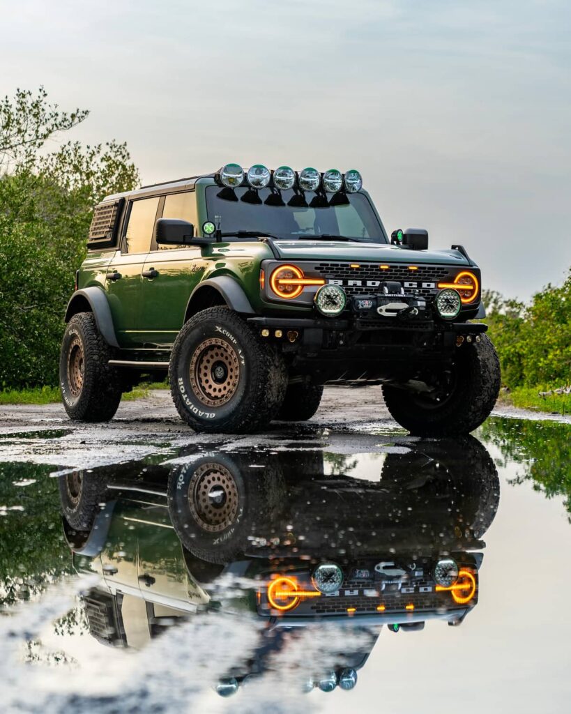 Green Ford Bronco 4 door on 37" tires with amber LED headlights