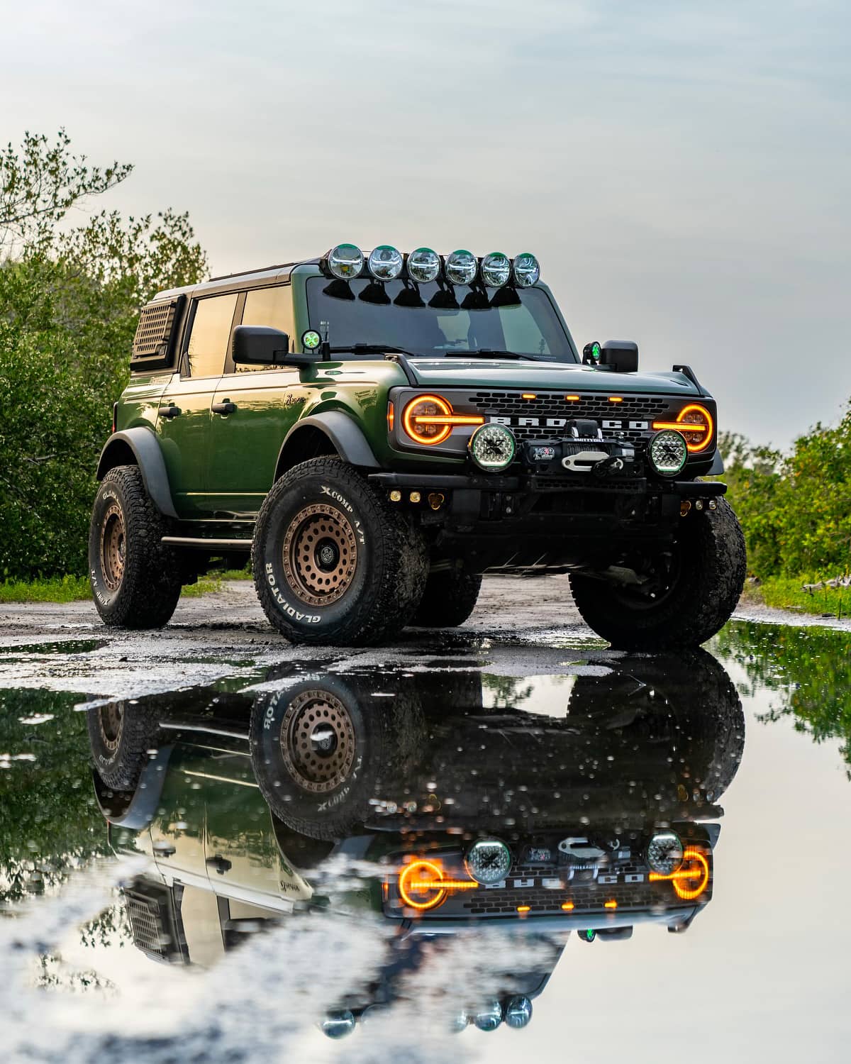 Lifted ford bronco Big Bend off road build on 37s in green color and bronze wheels