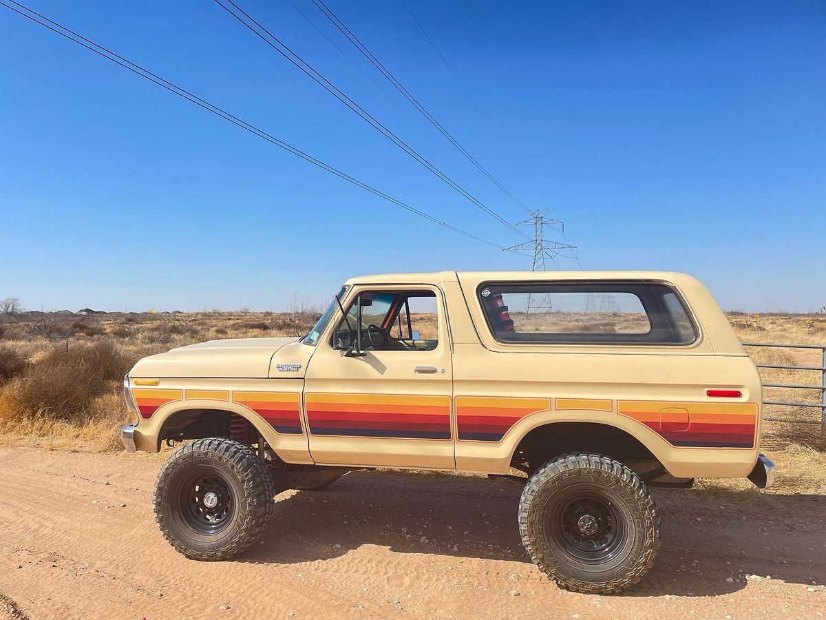 Side profile of a tan 1978 Ford Bronco Custom showing 5-inch suspension lift height