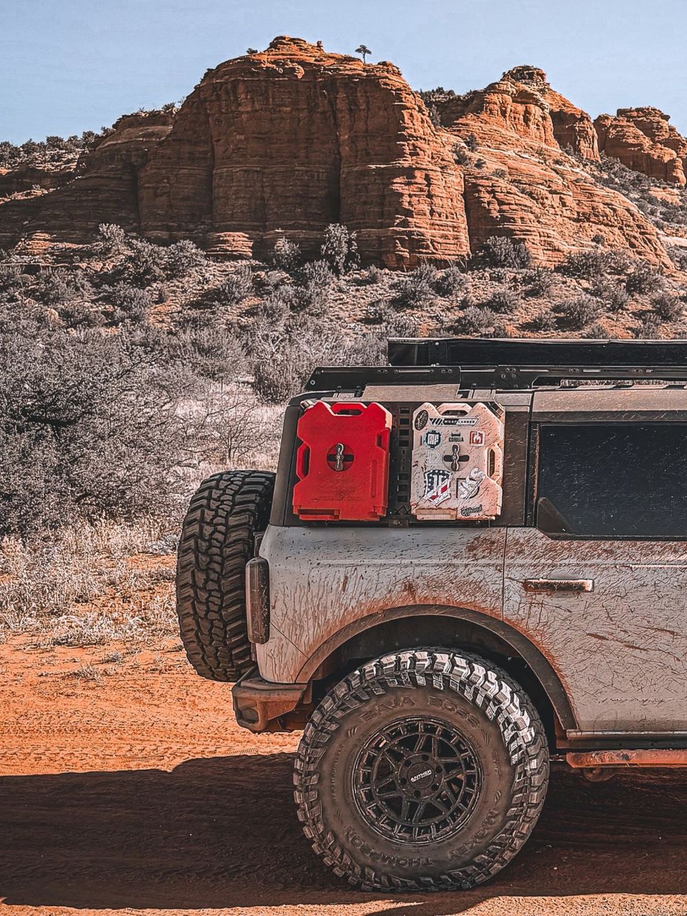 Mickey Thompson 37x13.50R17 tires on a lifted Ford Bronco at red rock canyon terrain