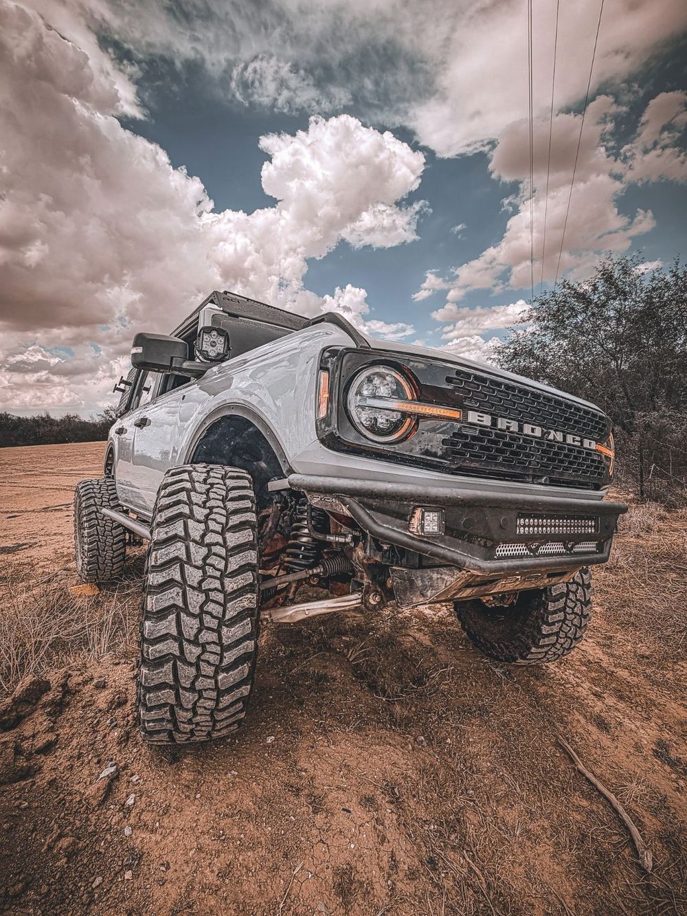 RCI rock sliders installed on a lifted Ford Bronco Wildtrak crawling over desert terrain
