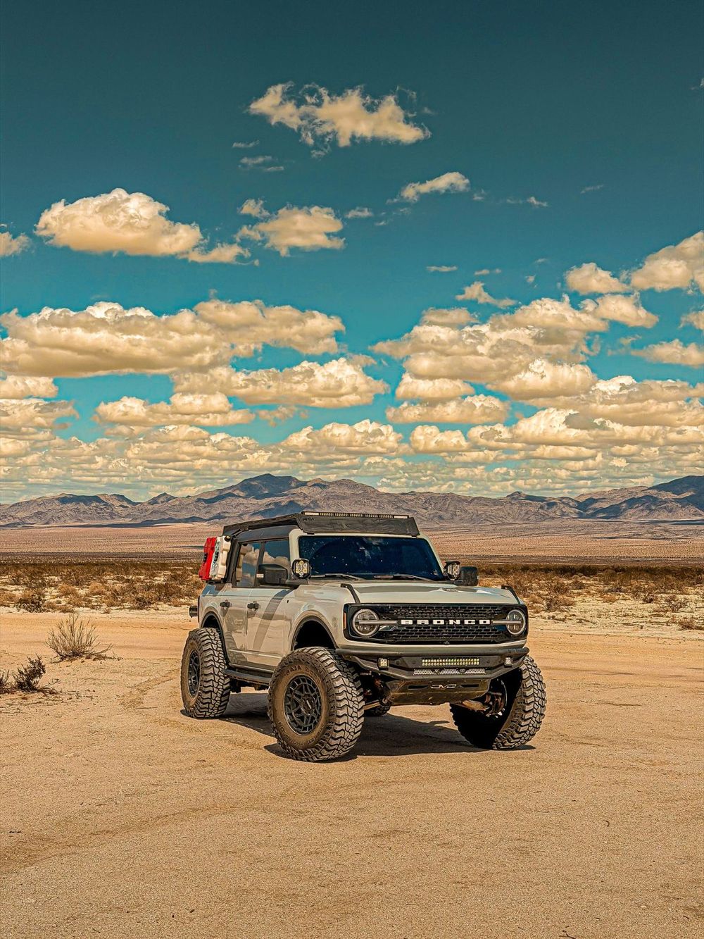 2022 Ford Bronco Wildtrak in white with 1-inch wheel spacers parked in open desert flats