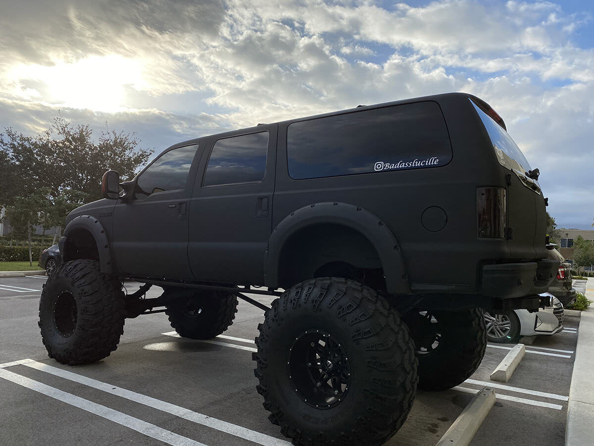 Matte Black Ford Excursion on Super swampers