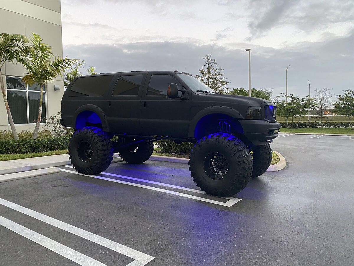 Matte black Lifted Ford Excursion on 49 inch off-road tires