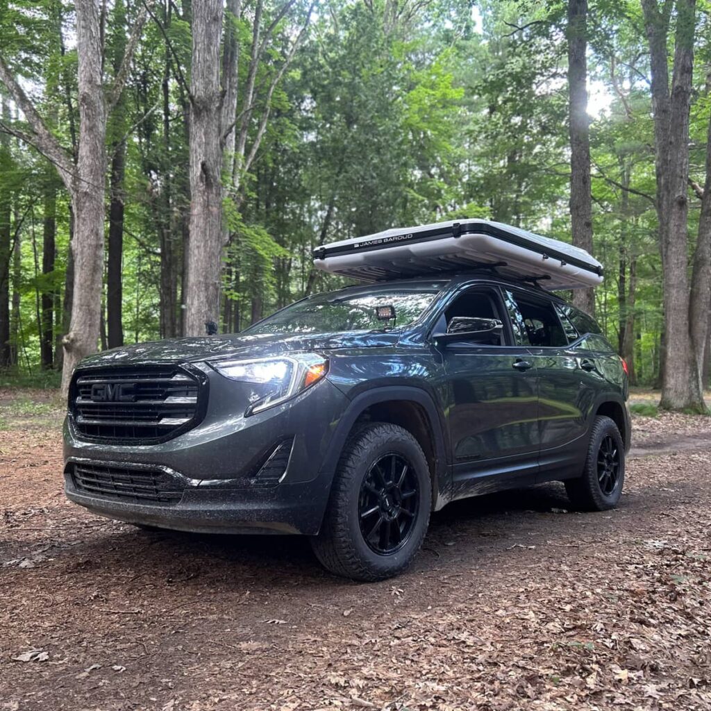 2019 GMC Terrain offroading in a forest with a James Baroud Odyssey tent