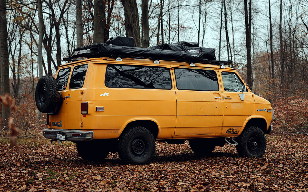 GMC camper van with a spare tire and a roof rack 235/85R16 Kumho MT 71