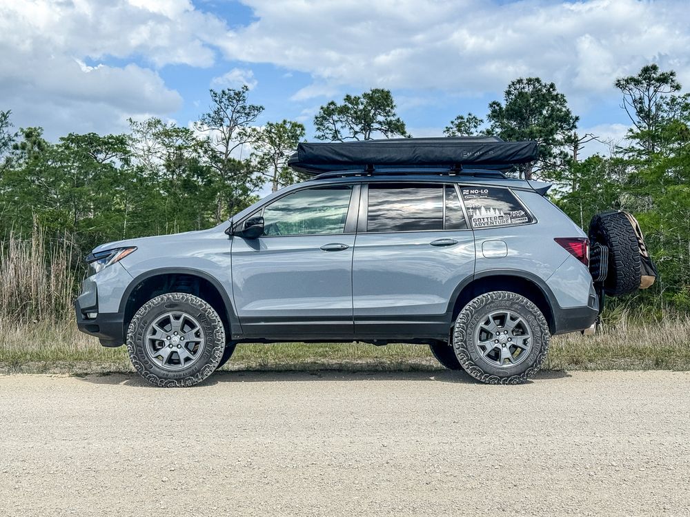 33-inch off-road tires fitted on a lifted Honda Passport TrailSport side profile view