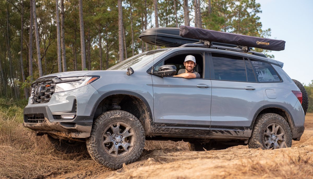 2024 silver Honda Passport TrailSport with i-VTM4 AWD climbing a sandy dirt trail
