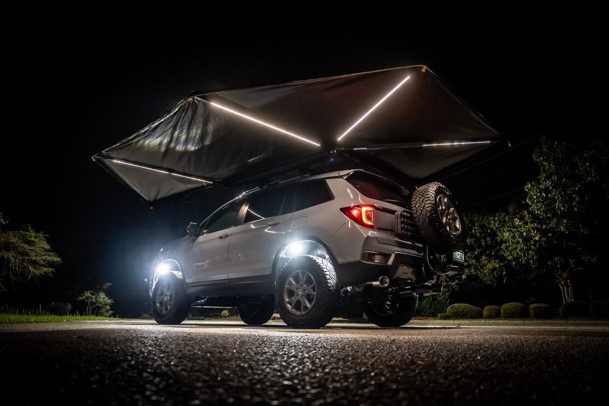 LED strip lighting illuminating the underside of an awning on a Honda Passport build