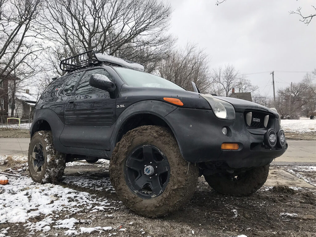 Isuzu Vehicross off-roading in mud black cladding