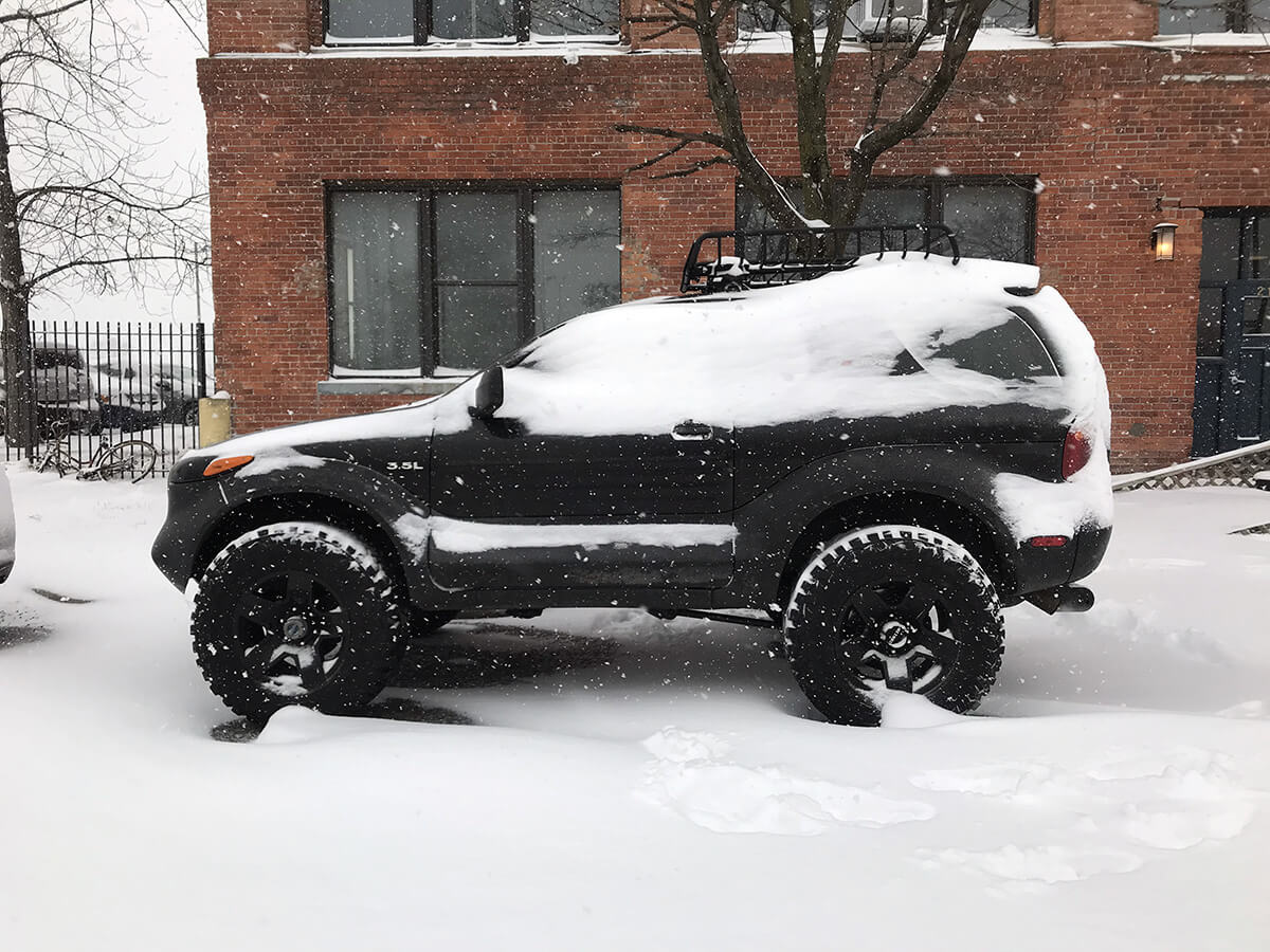 Black Isuzu Vehicross in snow