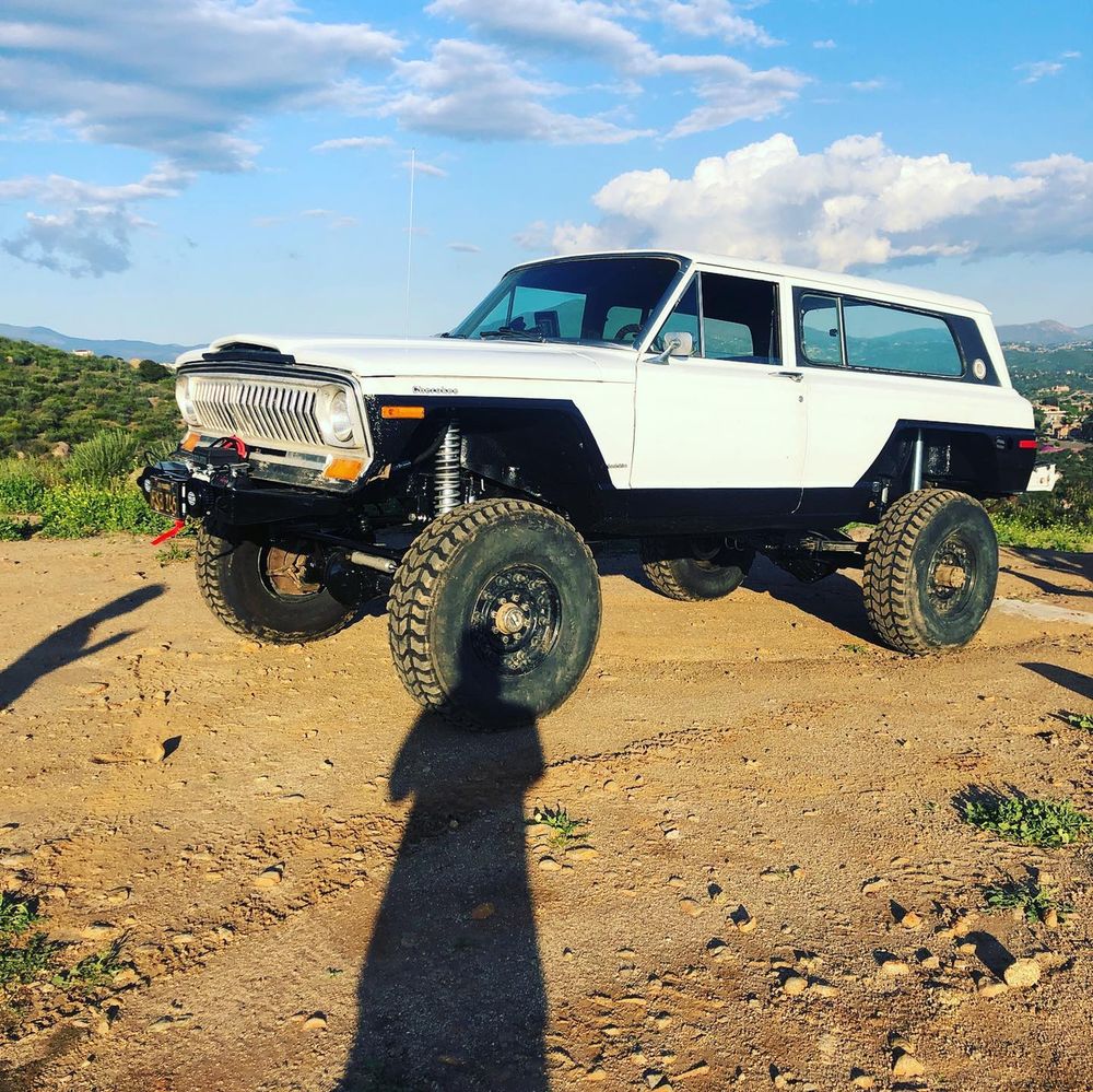 37-inch military Wrangler M/T tires on a lifted Cherokee SJ Chief on a hilltop dirt trail