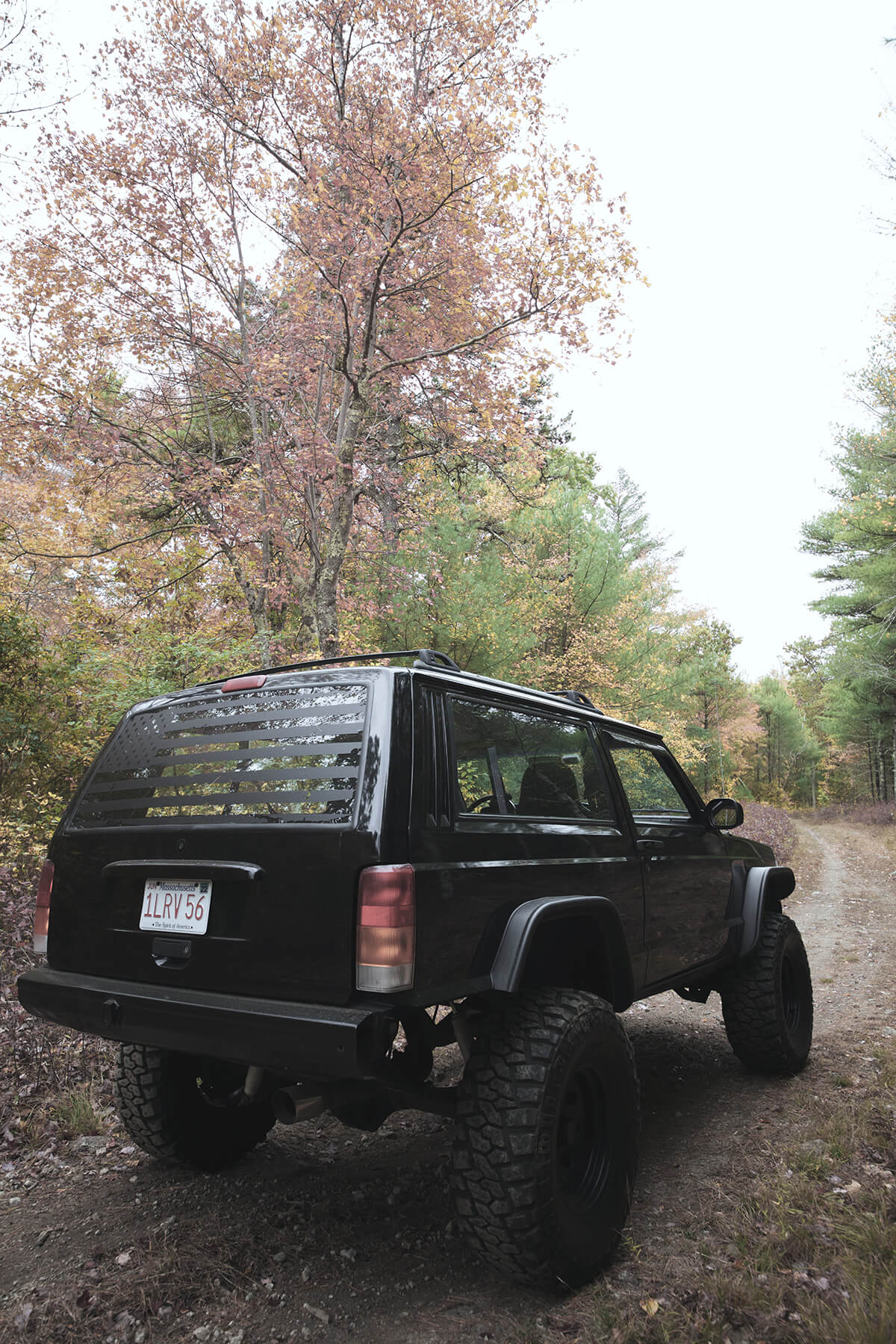 Black Jeep Cherokee XJ with bushwacker fender flares - rear view