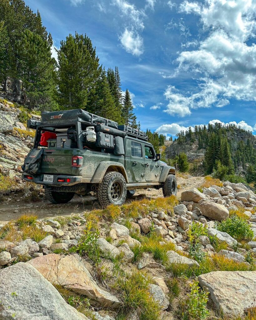 Jeep Gladiator overland truck bed loaded with accessories in the mountains