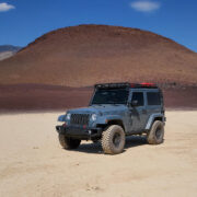 Light blue lifted jeep Wrangler rubicon in the desert sands