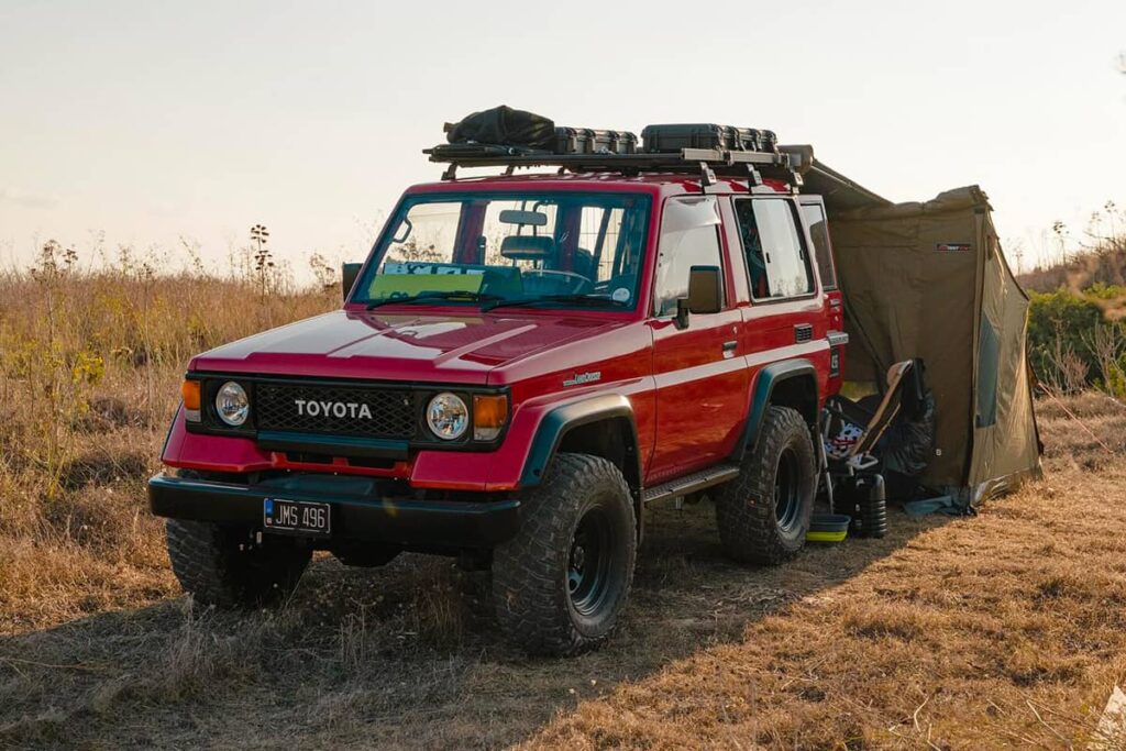 Red Toyota Land Cruiser 70 off road camping