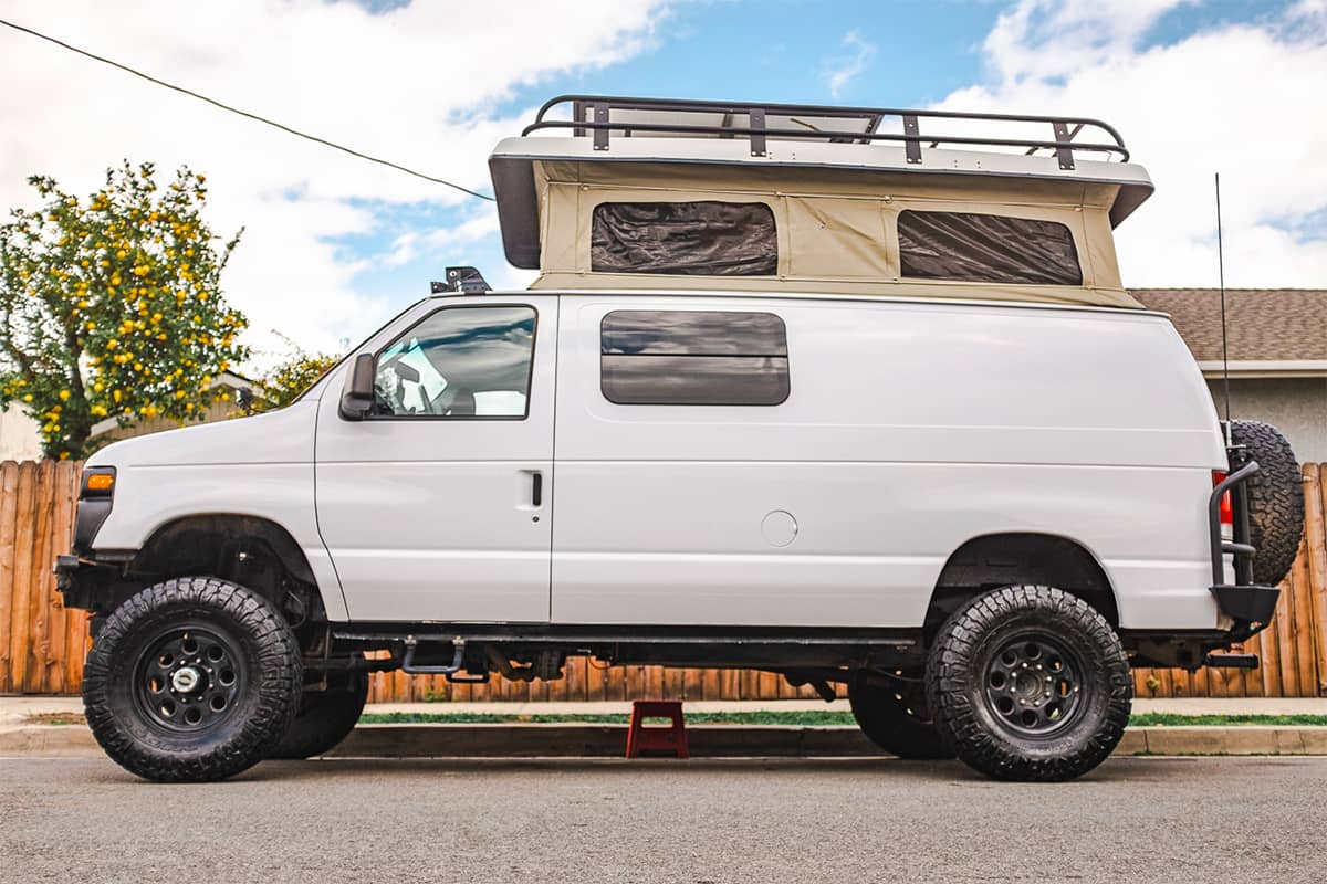 Ford 250 Offroad 4x4 van with Sportsmobile electric pop top roof and overland cargo rack