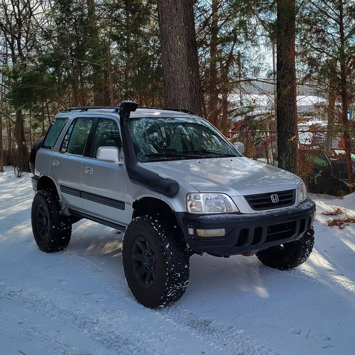 Lifted Honda CR-V with off-road wheels and a snorkel