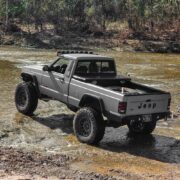 off-roading in a lifted Jeep Comanche XJ truck with off-road modifications