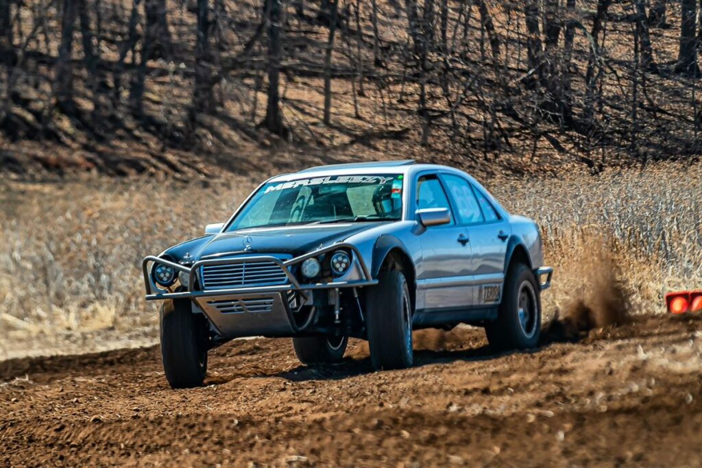 Mercedes W210 prerunner with Fox hydraulic bump stops absorbing terrain at speed off-road