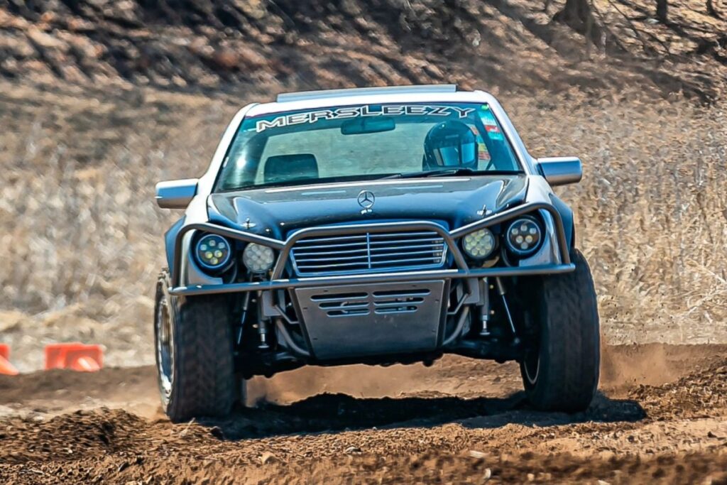 Round LED off-road lights mounted on the tube bumper of a Mercedes W210 prerunner