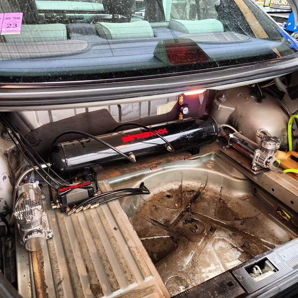 AirMaxxx air tank and dual compressor setup mounted in the trunk of a Mercedes W210