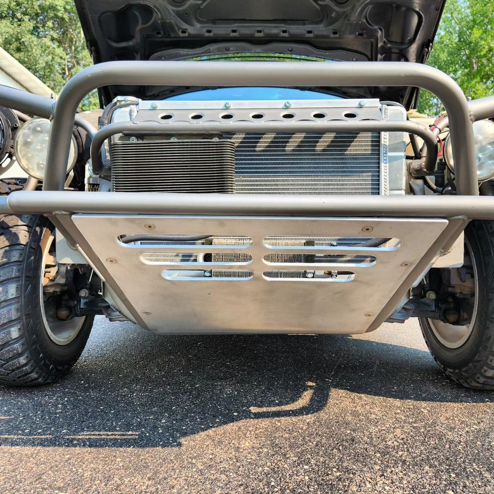 Aluminum skid plate with vented louvres protecting the front undercarriage of a W210 prerunner
