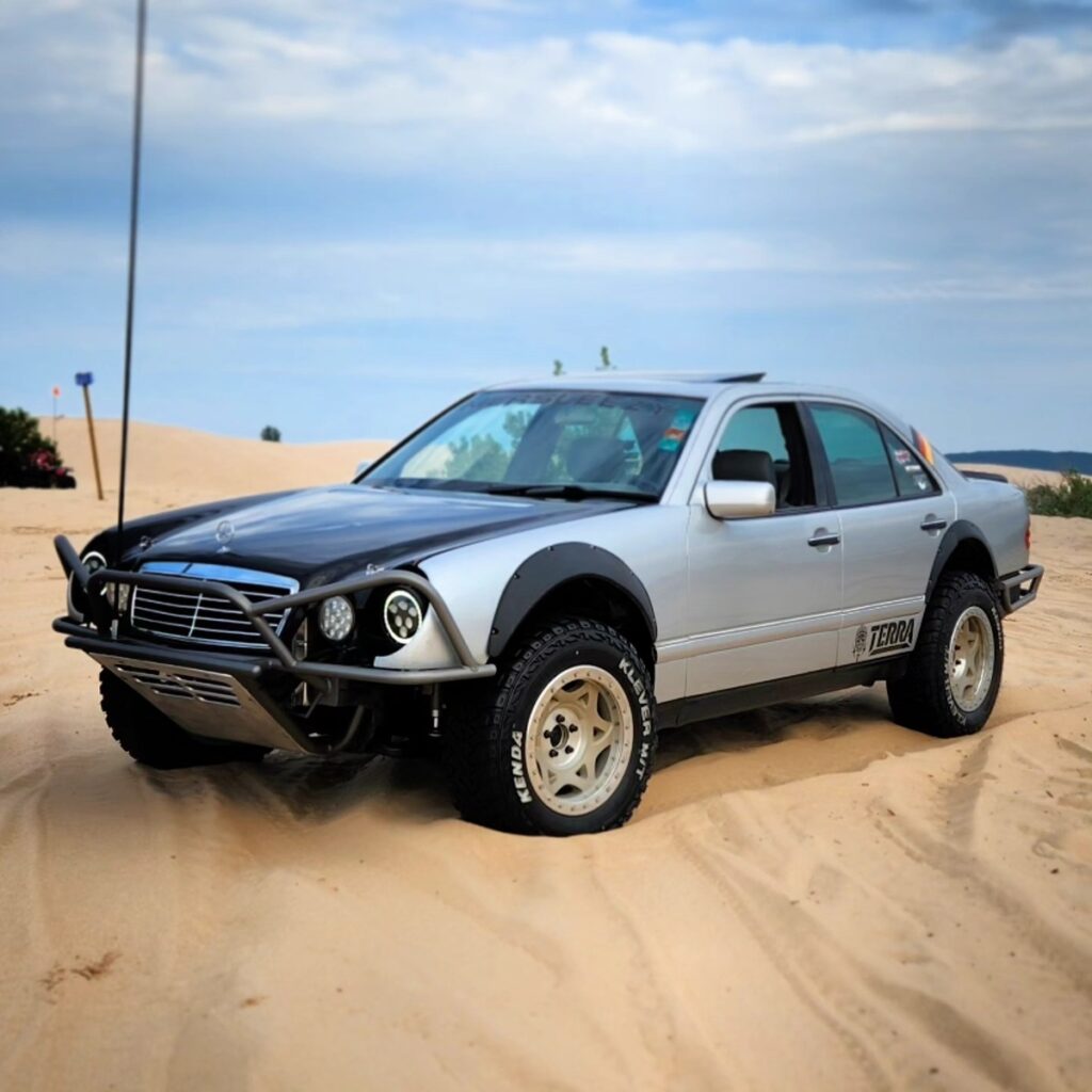 1998 Mercedes E430 silver off-road prerunner on sand dunes with Kenda Klever MT tires