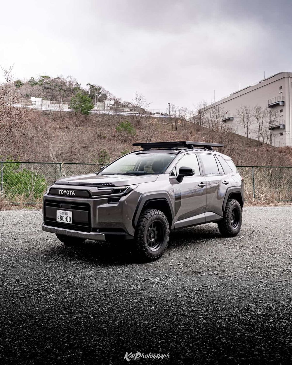 2026 Toyota RAV4 6th gen in gray with a Front Runner roof rack on a gravel lot