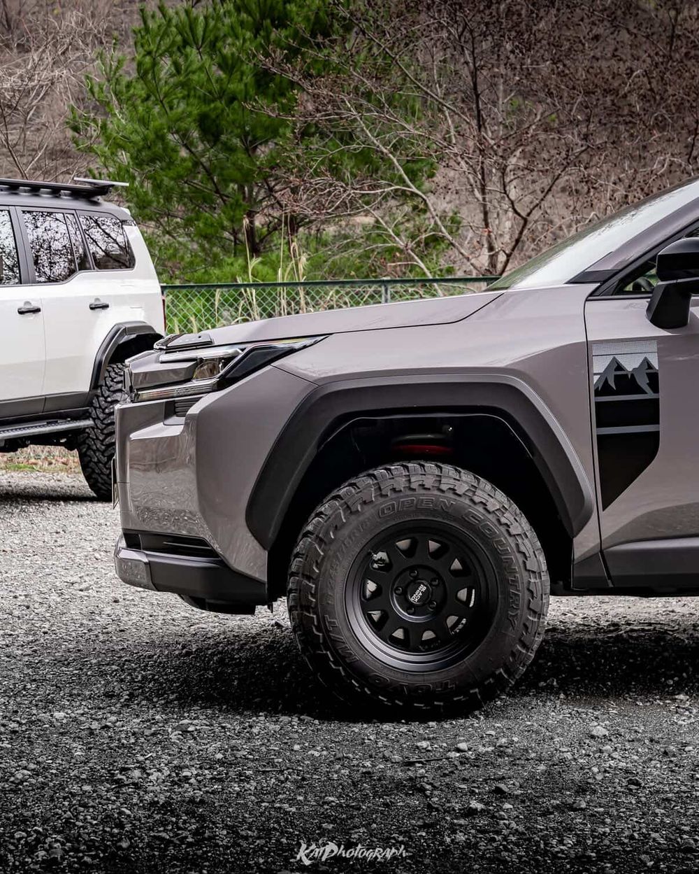 TOYO Open Country M/T tire mounted on a black steel wheel on a lifted RAV4