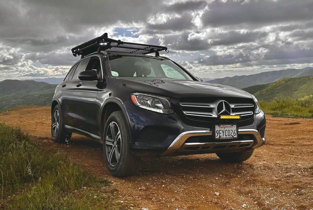 Mercedes glc300 with an overland roof rack, tent and a roadshower