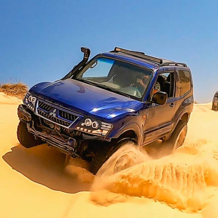 Mitsubishi Pajero SUV off-road in mountain terrain