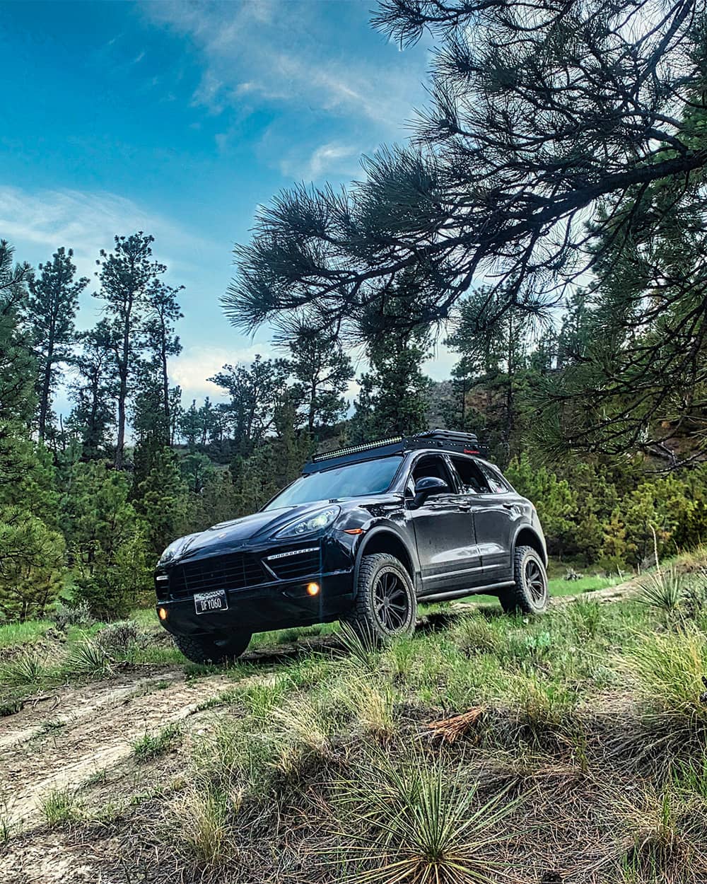 Off-roading in a black lifted Porsche Cayenne 958 turbo