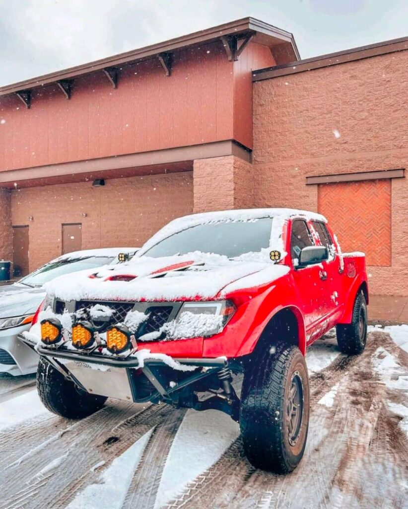 Nissan Frontier D40 with a wide body kit and long travel suspension