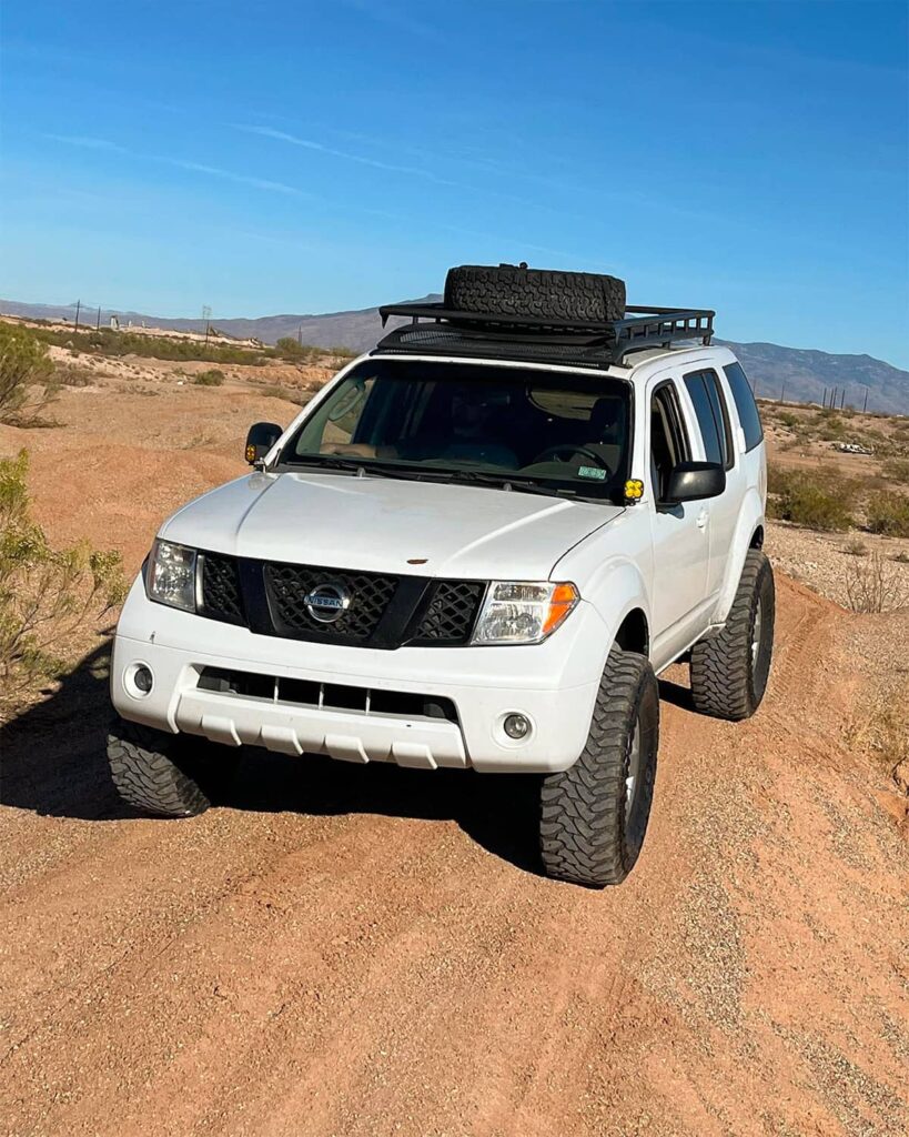 Lifted Nissan Pathfinder R51 with a custom full-length roof rack