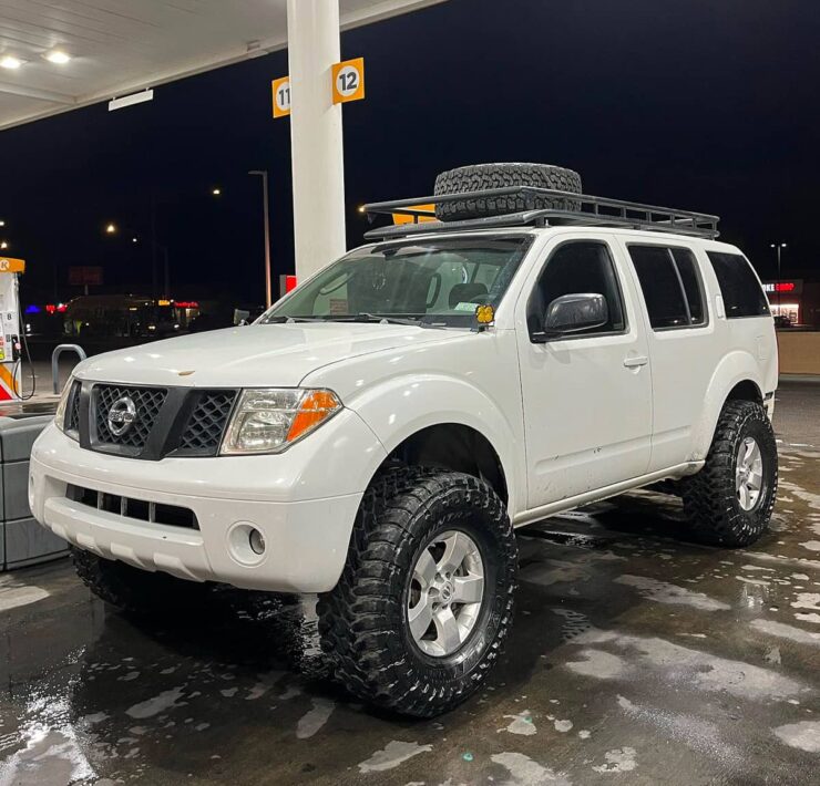 White Nissan Pathfinder with a titan suspension and 35 inch tires