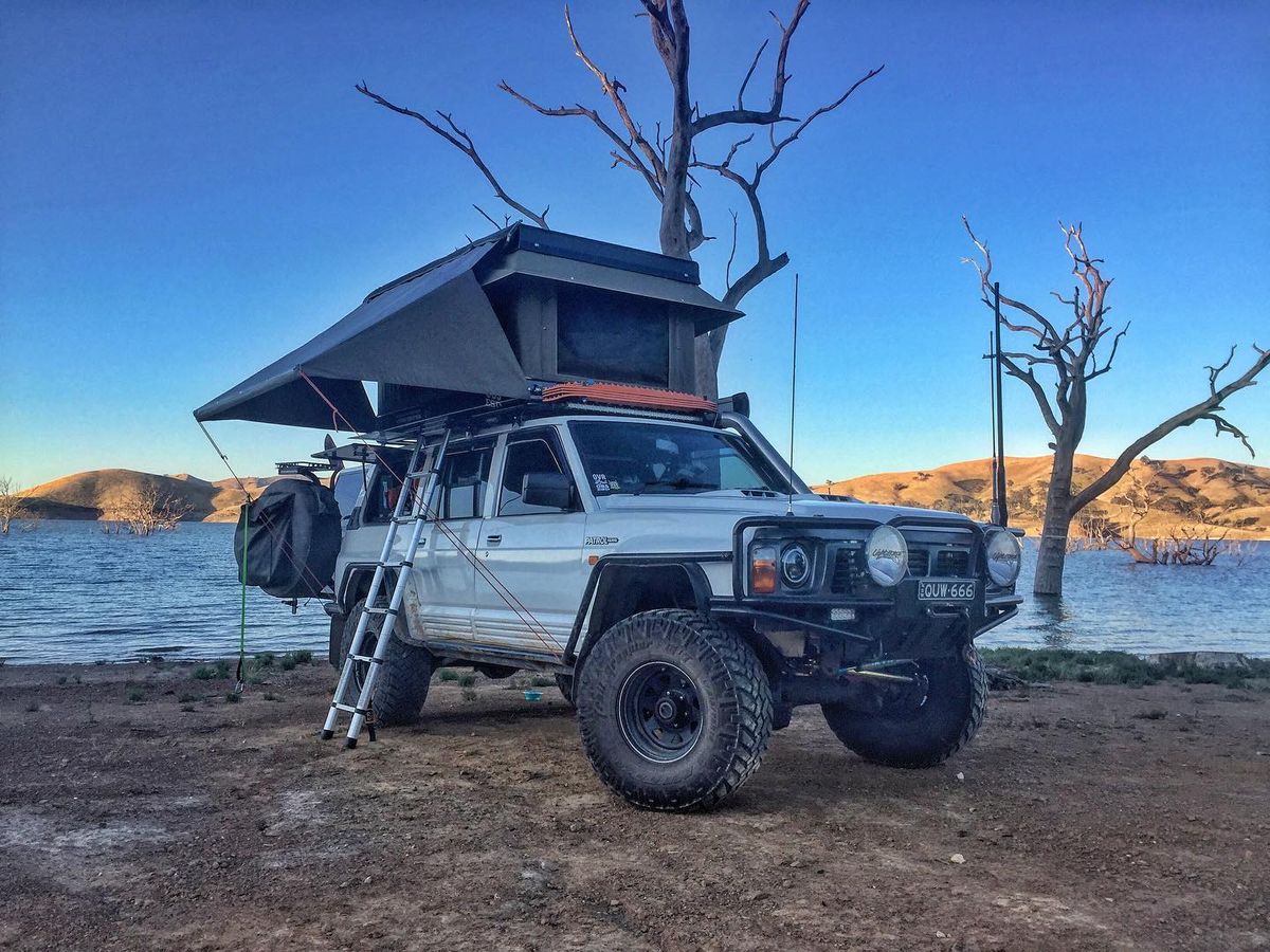 1992 Nissan Patrol Y60 overland build with a hardshell electric clamshell rooftop tent deployed
