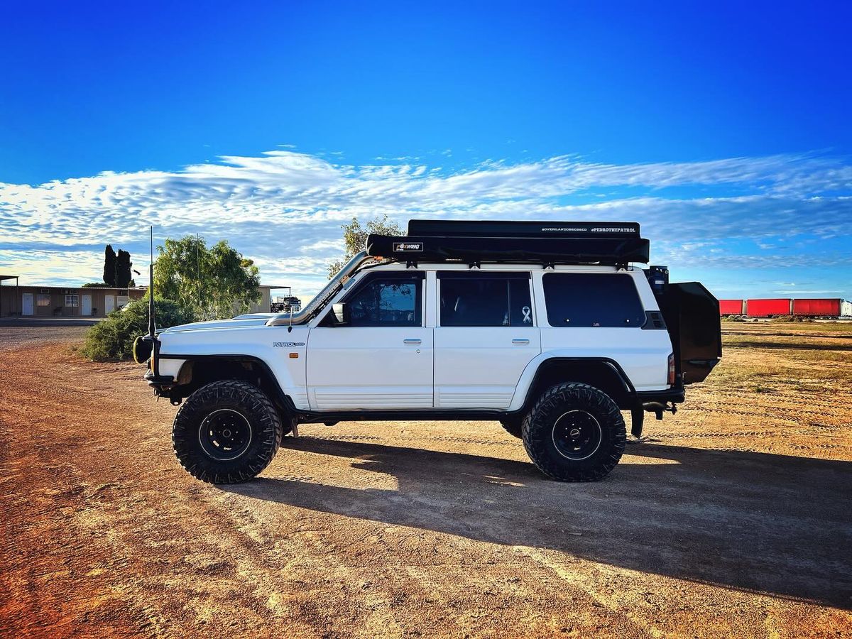 315/75R16 Nitto Trail Grappler mud-terrain tires on a lifted white Nissan Patrol Y60 GQ