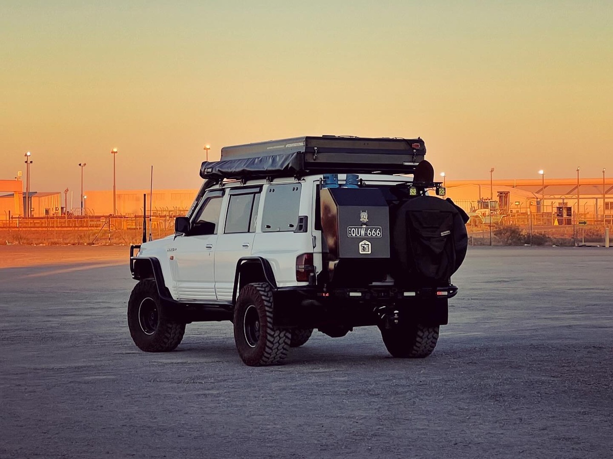 Dual-pivot swing-away rear bumper with spare tire + gear/laundry bag with Scrubba bag